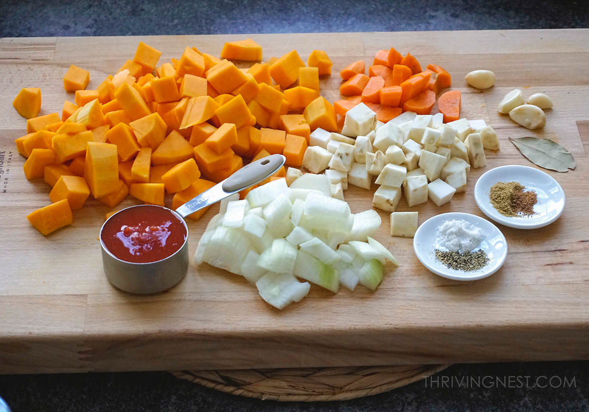 Ingredients for the butternut squash soup - gluten free, dairy free, grain free: cubed butternut squash, cubed carrots, cubed celeriac, chopped onion, tomato, coriander, nutmeg, bay leaf, salt and pepper.