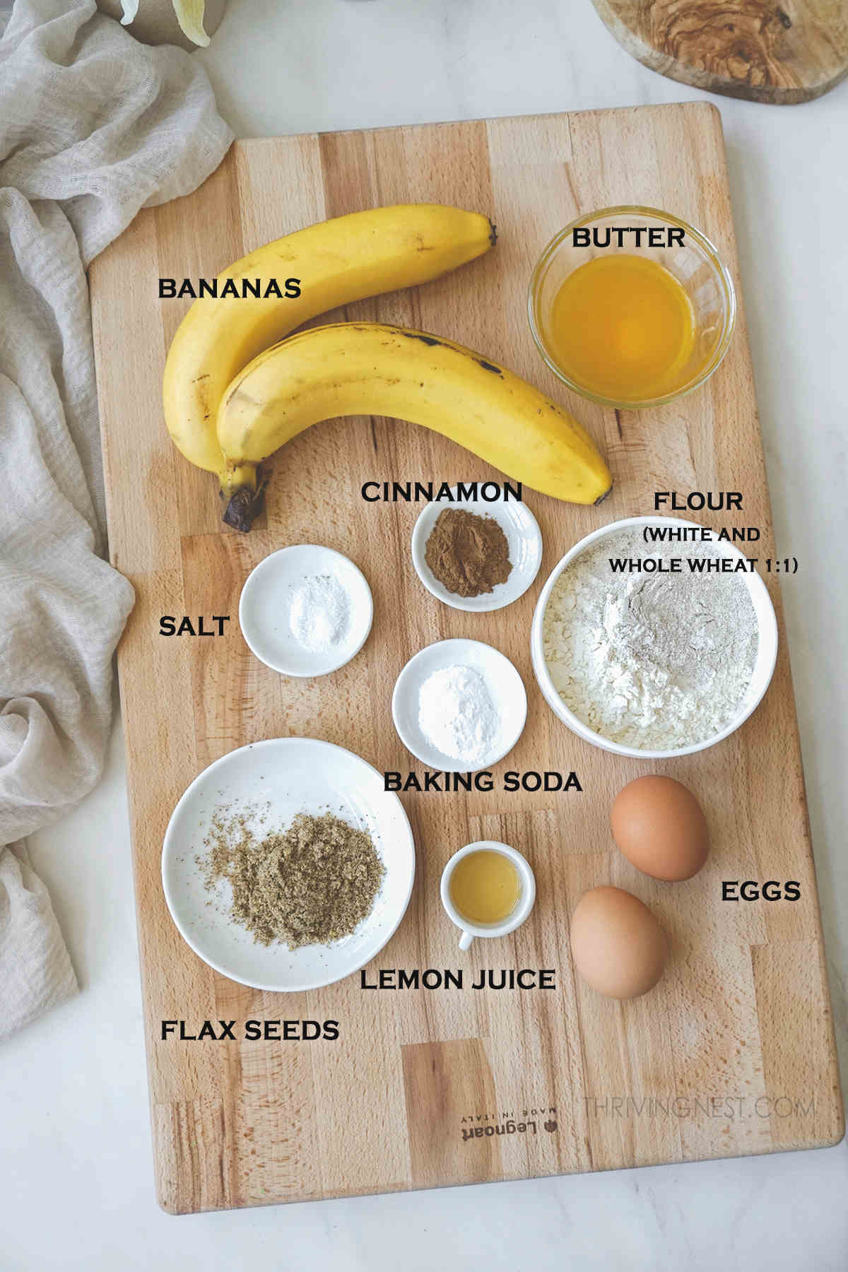 Ingredients needed for baby banana bread recipe displayed on a board.