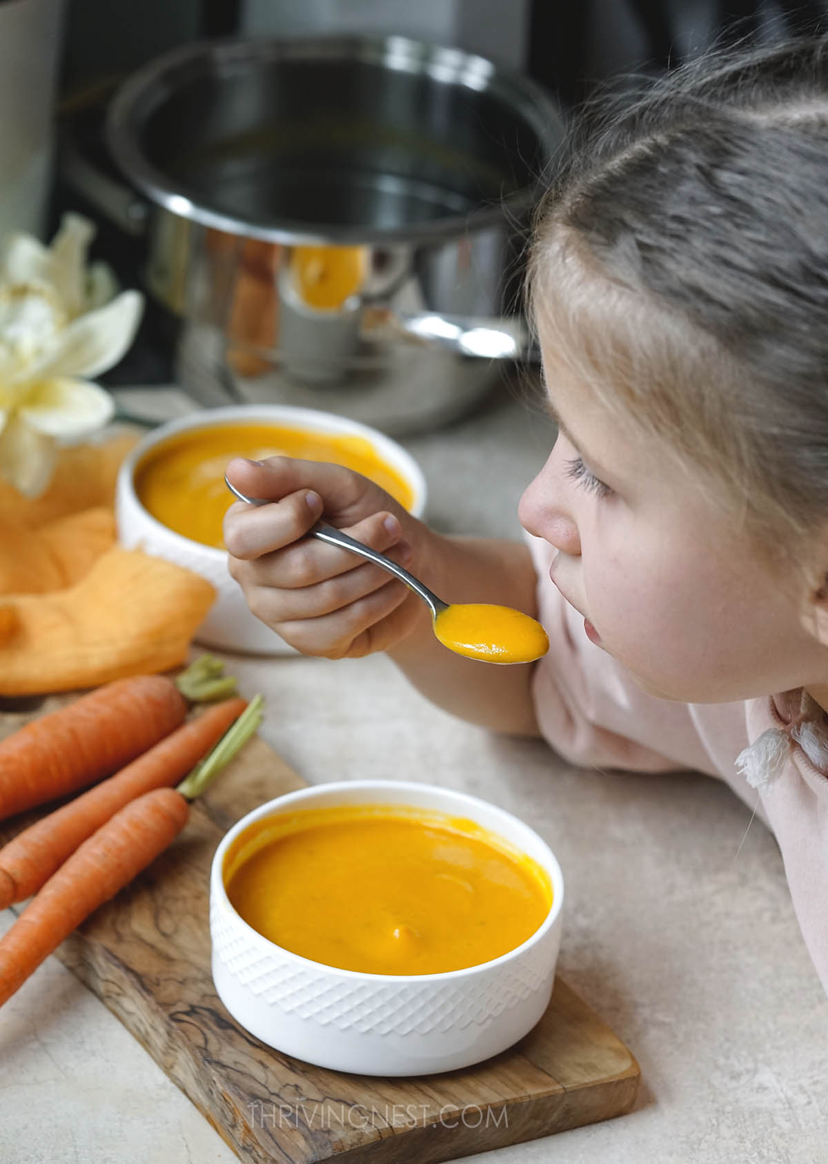 My daughter eating carrot soup.