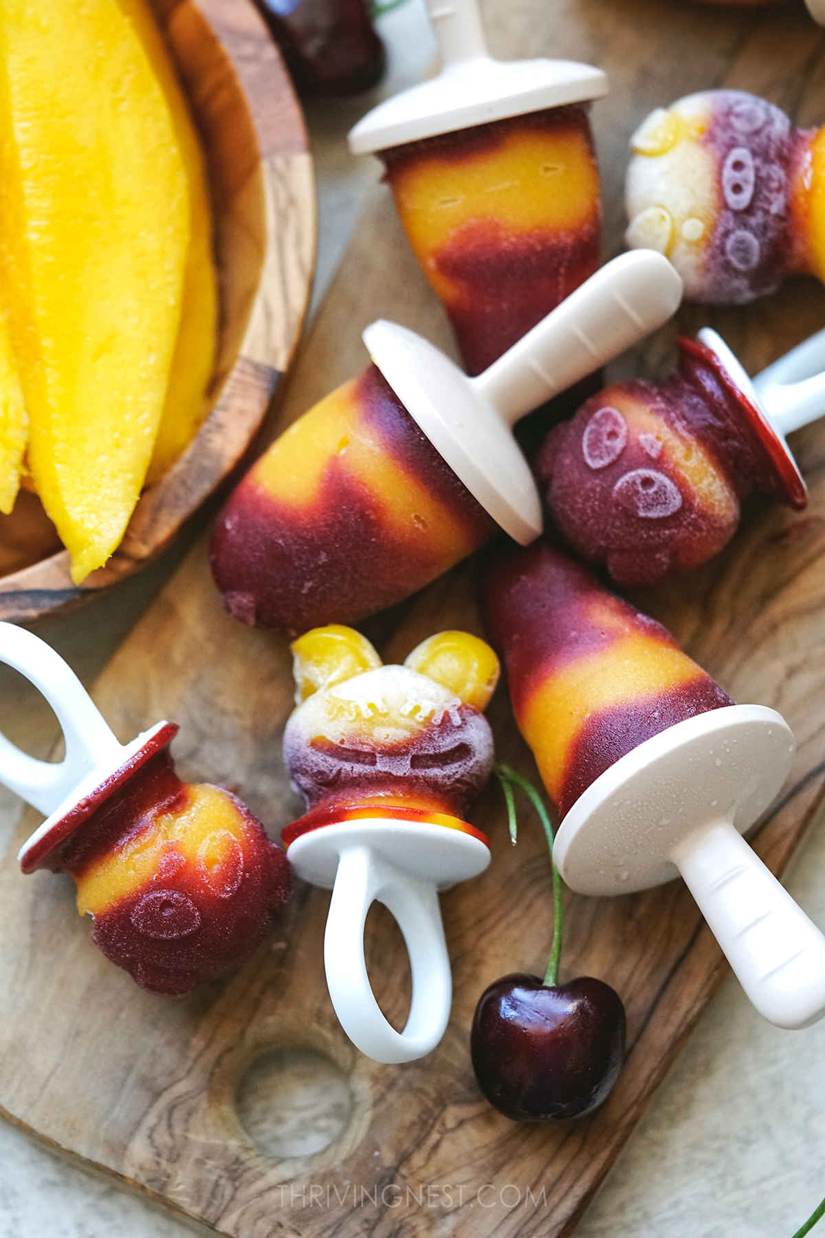 Mango and cherry popsicles made with animal silicone molds.