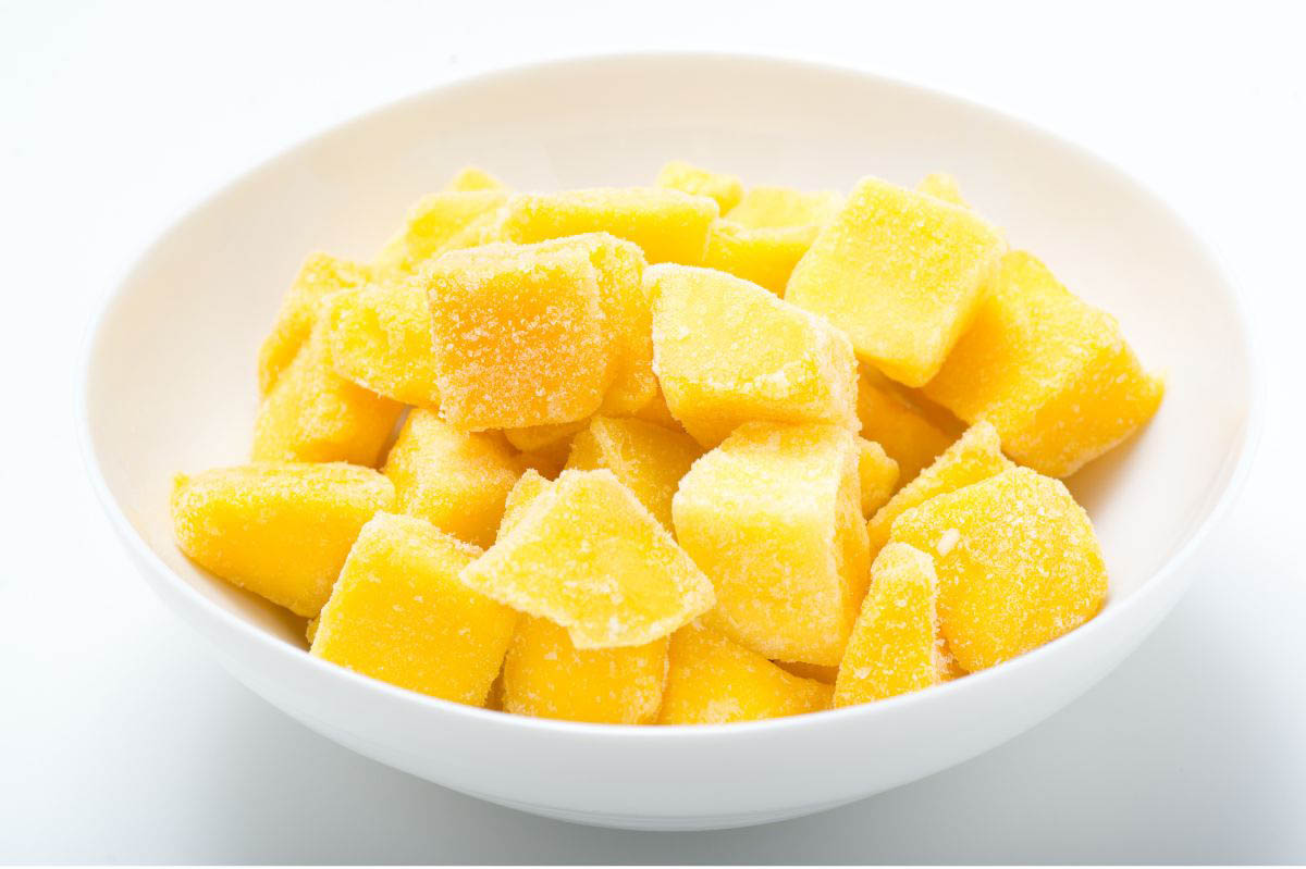 Frozen mango cubes in a plate.