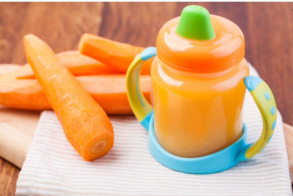 Carrot juice or soup in a sippy cup for baby.