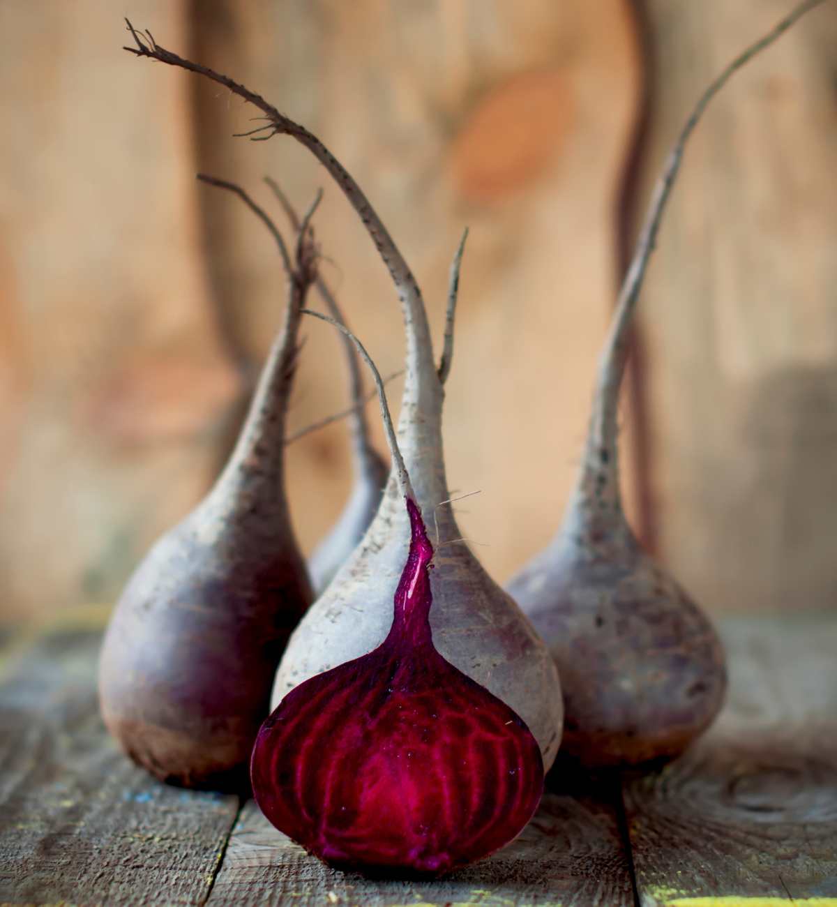 Image of raw beets, one cut in half.