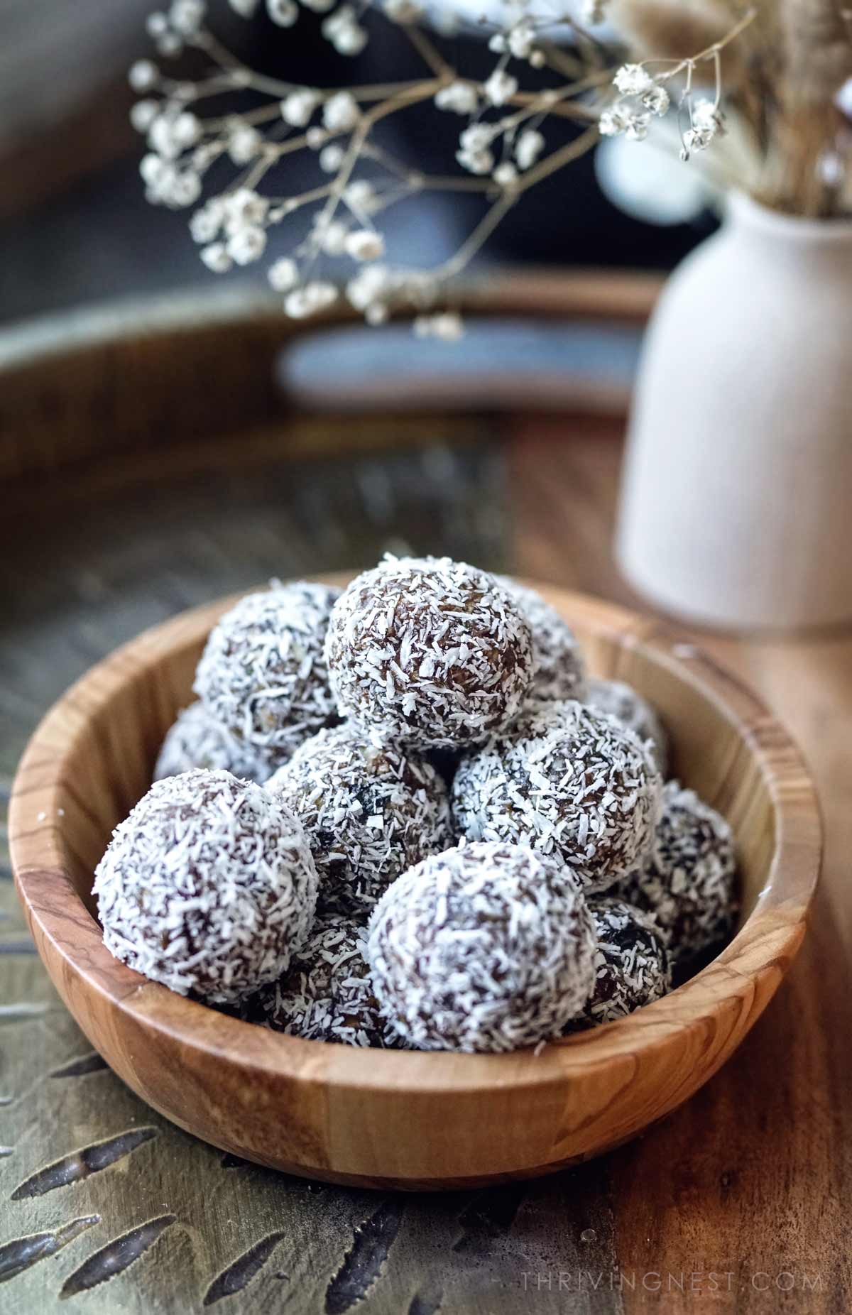 Energy bliss bites as snack for kids stacked in a bowl.